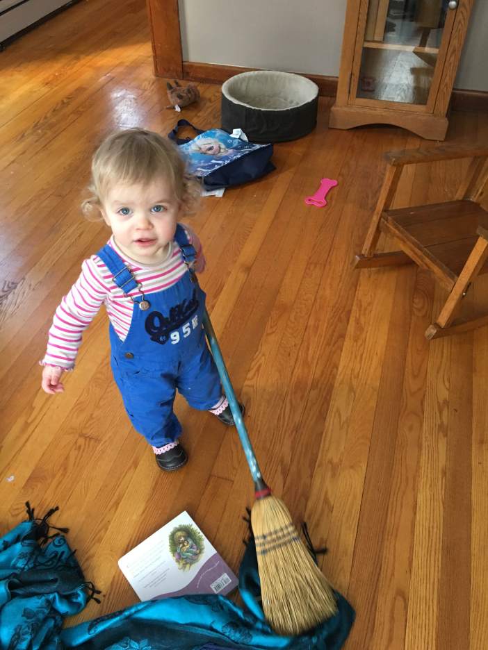 Eve loves to help me sweep the floors.